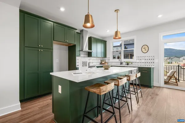 a kitchen with stainless steel appliances a table chairs and chandelier
