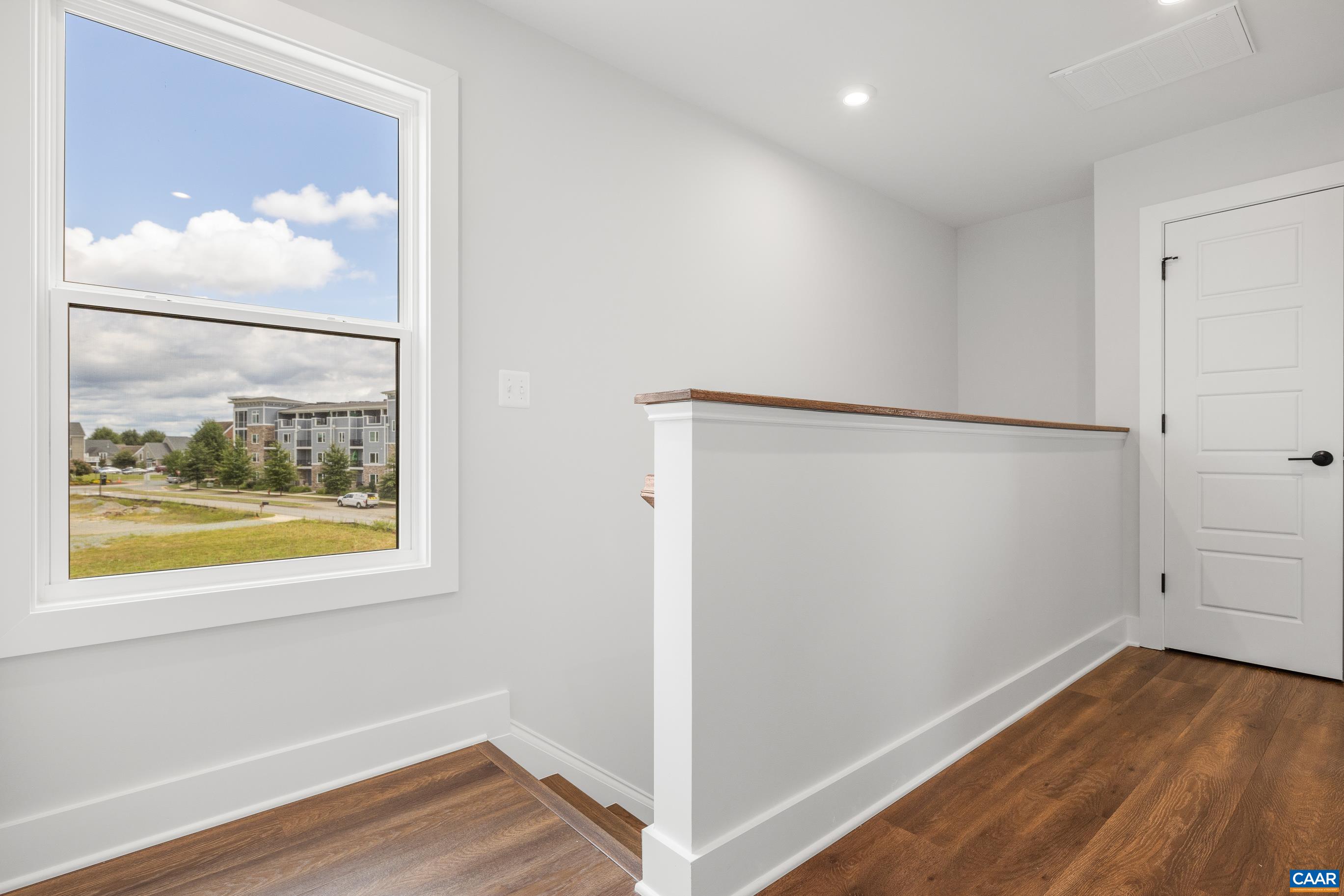 14 B Larkin Avenue Crozet, VA 22932 - Photo 22 of 40 a view of an empty room with wooden floor and a window