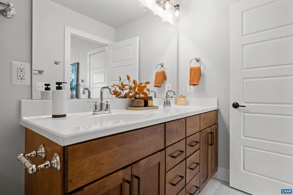 a bathroom with a sink vanity and a mirror