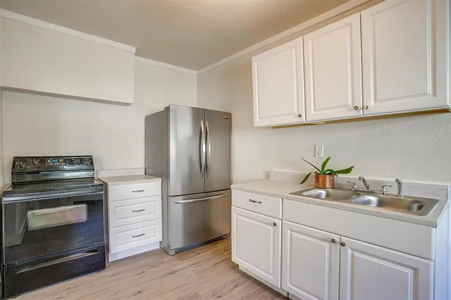 a kitchen with appliances cabinets and a counter top space