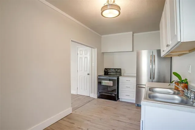 a kitchen with stainless steel appliances a refrigerator and a sink