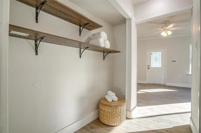 a view of a room with a door and wooden floor