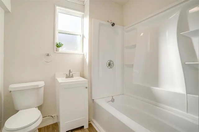 a bathroom with a toilet a sink and bathtub