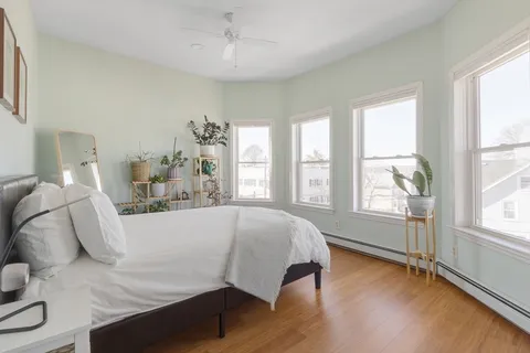 a bed sitting in a bedroom next to a window