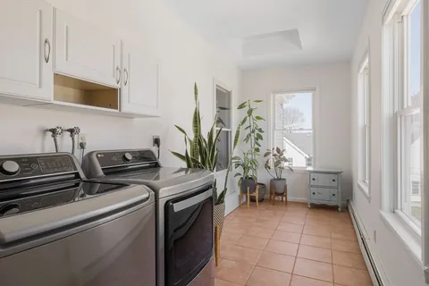a kitchen with a stove and white cabinets