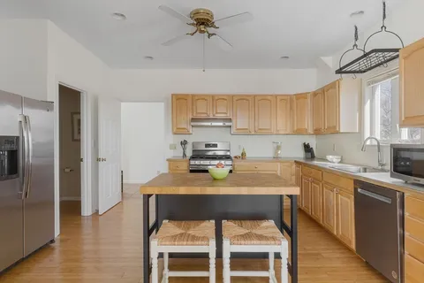 a kitchen with a refrigerator a sink and cabinets