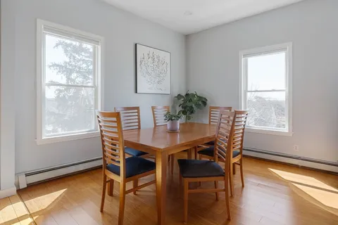 a view of a dining room with furniture and wooden floor