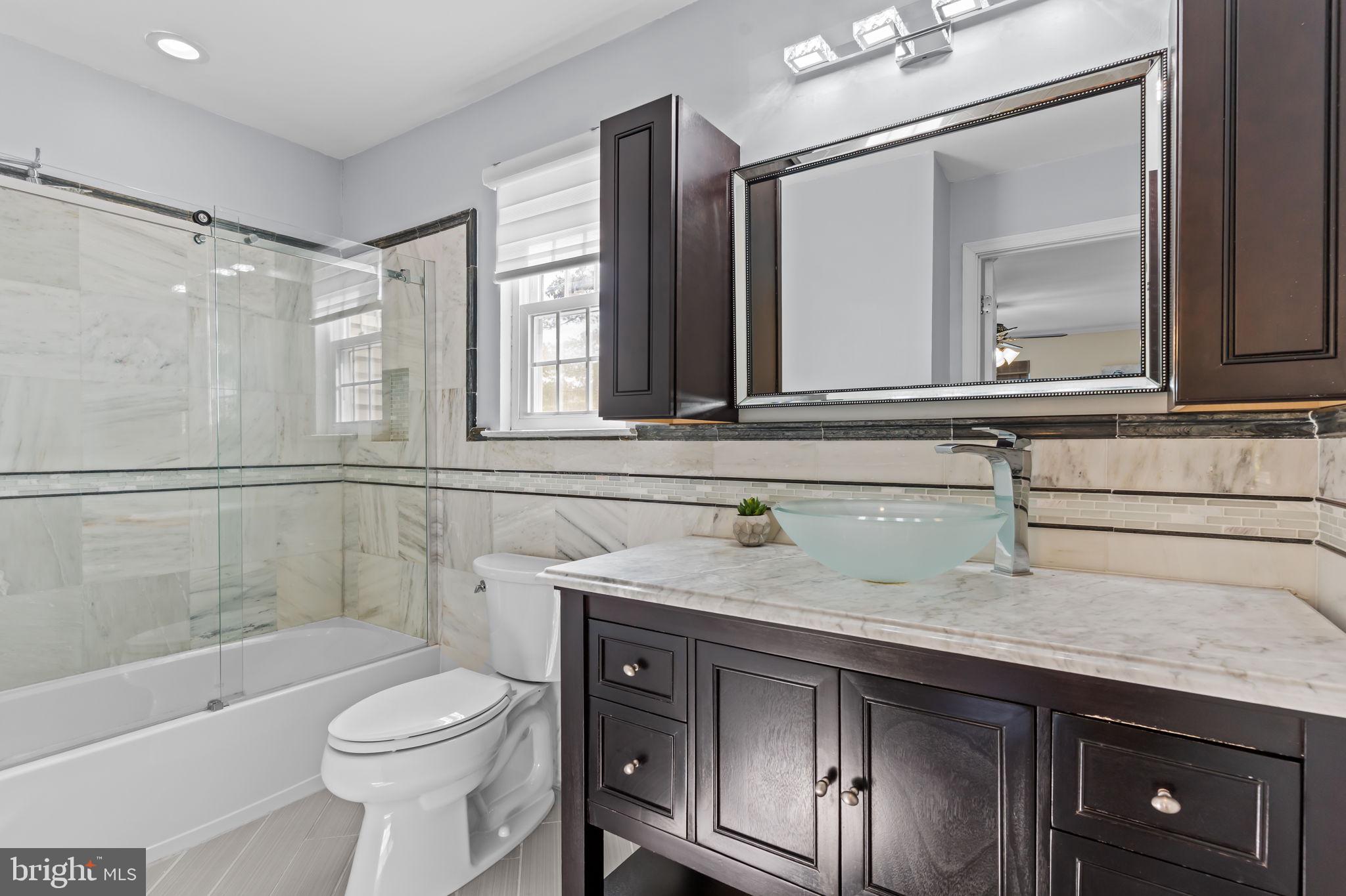 15 East Park Road Newtown, PA 18940 - Photo 21 of 35 a bathroom with a sink a toilet and shower