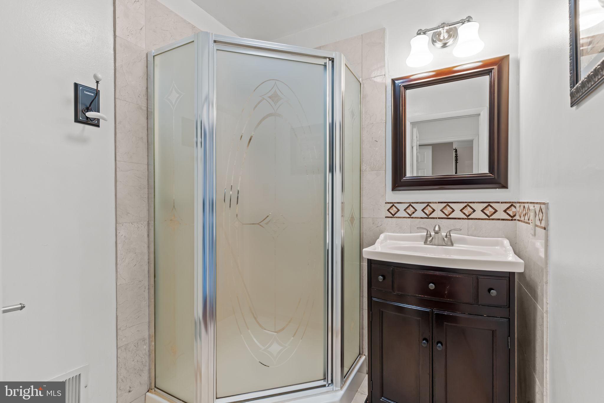 15 East Park Road Newtown, PA 18940 - Photo 25 of 35 a bathroom with a sink a mirror and a shower