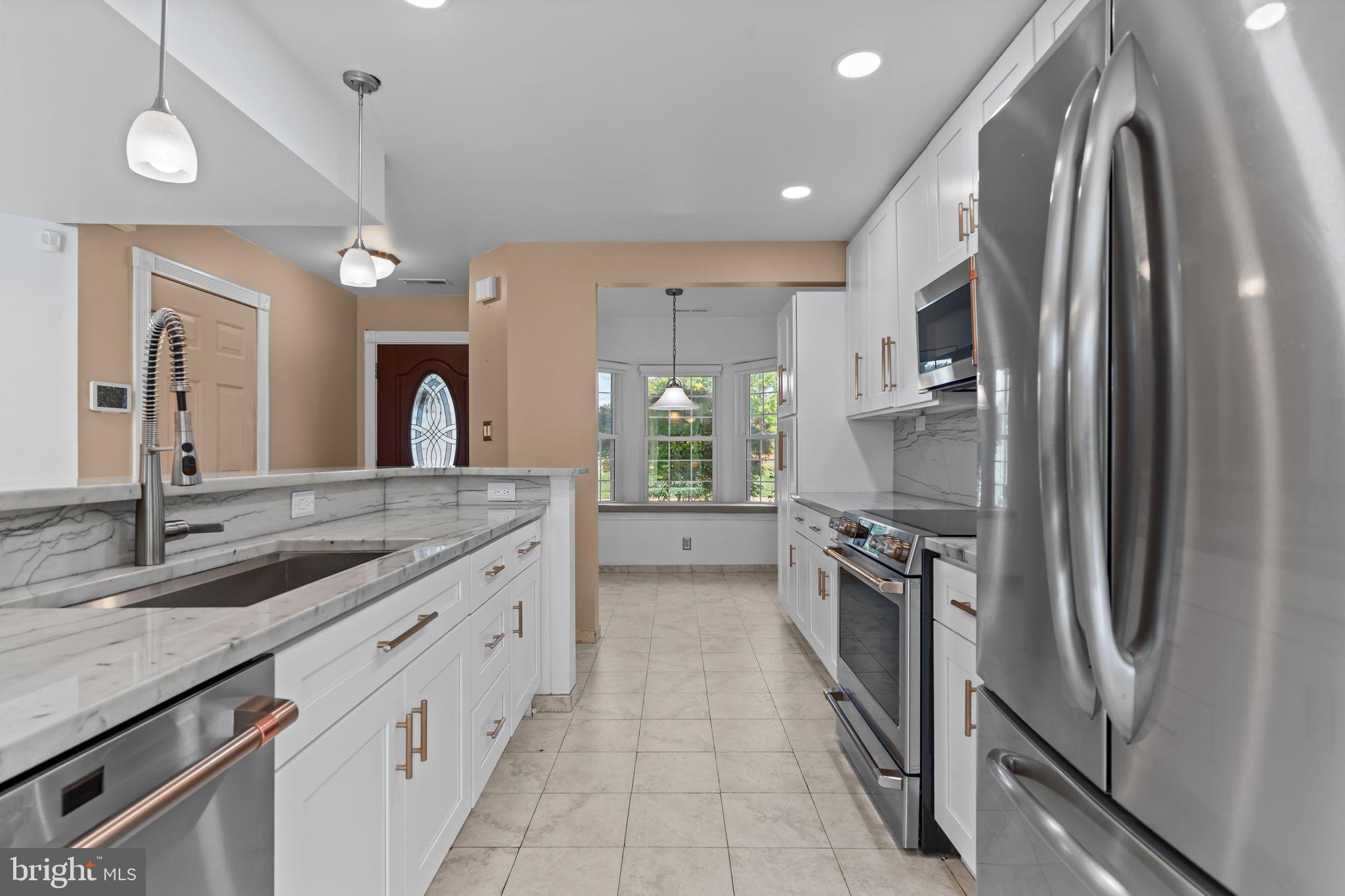 15 East Park Road Newtown, PA 18940 - Photo 3 of 35 a kitchen with stainless steel appliances granite countertop a sink and a refrigerator