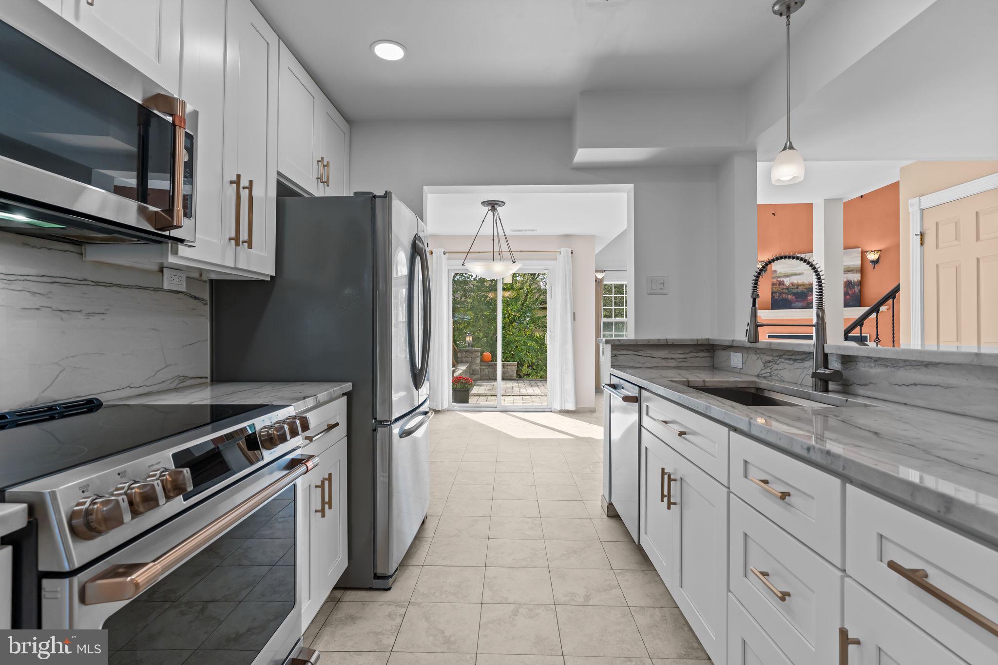 15 East Park Road Newtown, PA 18940 - Photo 5 of 35 a kitchen with granite countertop a stove and a sink