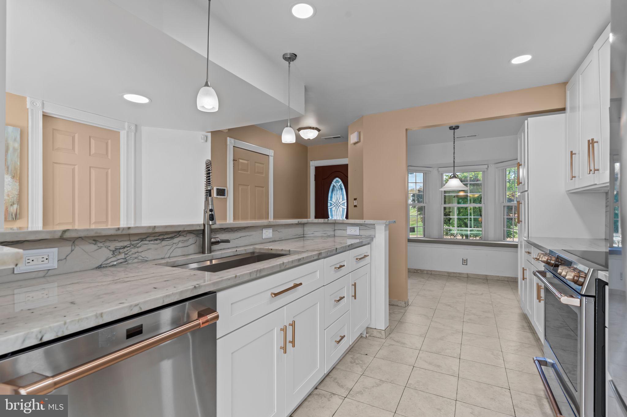 15 East Park Road Newtown, PA 18940 - Photo 6 of 35 a spacious bathroom with a granite countertop double vanity sink a mirror and a bathtub