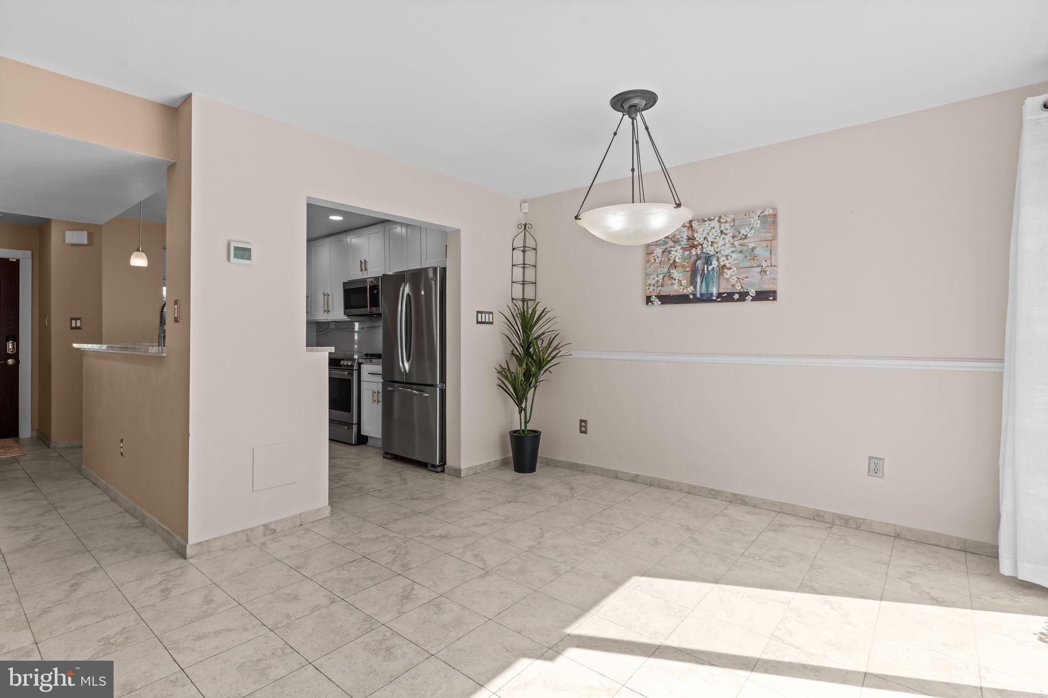 15 East Park Road Newtown, PA 18940 - Photo 10 of 35 a view of a hallway with wooden floor and a chandelier