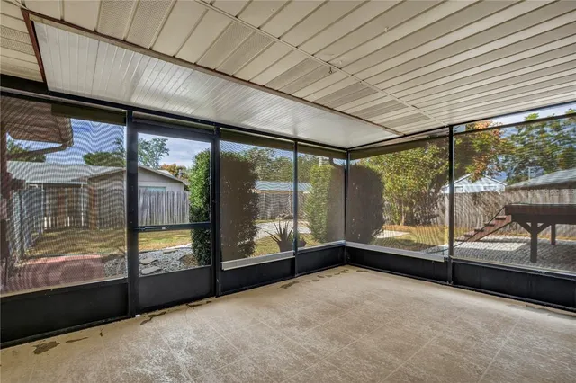 a view of an empty room with large windows