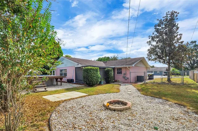 a view of a house with swimming pool and a yard
