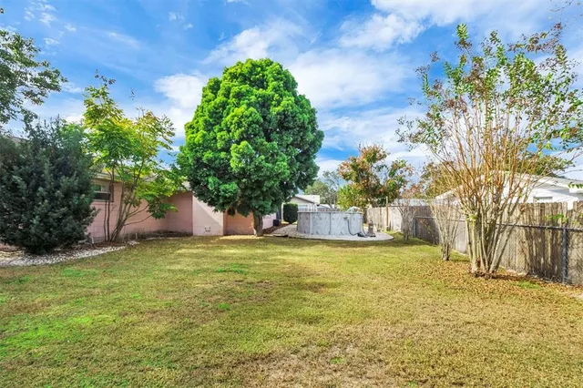 a view of a yard with palm trees