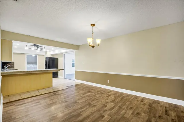 a view of a kitchen with a dishwasher cabinets and wooden floor
