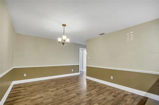 a view of room with wooden floor and ceiling fan