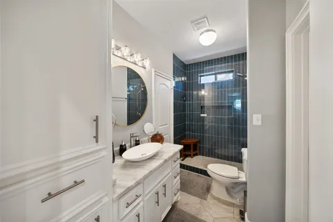 a bathroom with a sink toilet and shower