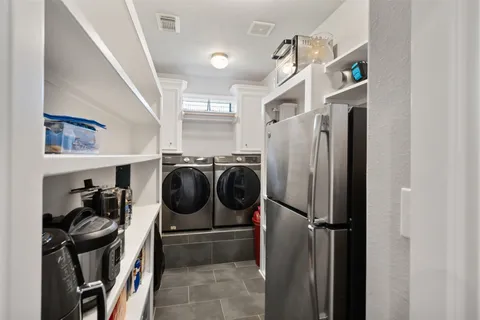 a utility room with closet dryer and washer