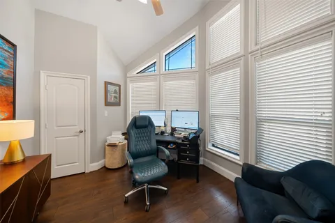 a view of a workspace with furniture and a window