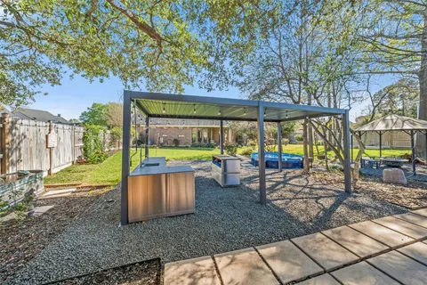 a view of a patio with a table chairs and a backyard