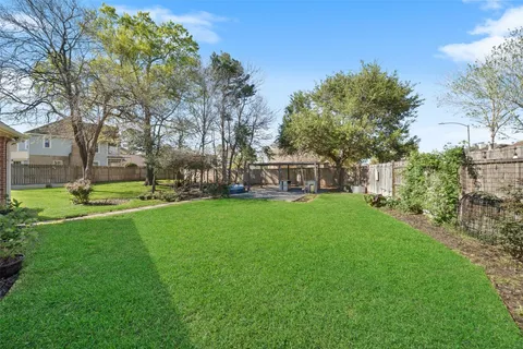 a view of a house with backyard and sitting area