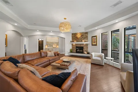 a living room with furniture fireplace and a large window
