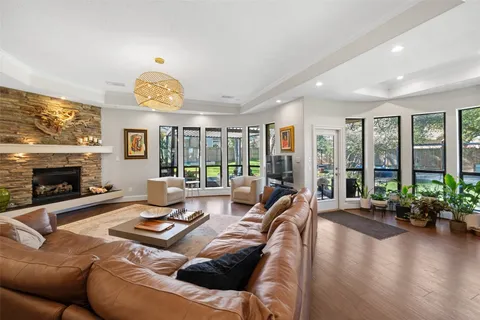 a living room with furniture fireplace and a large window