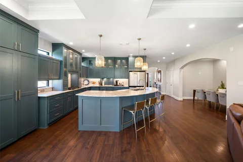 a large kitchen with a table and chairs