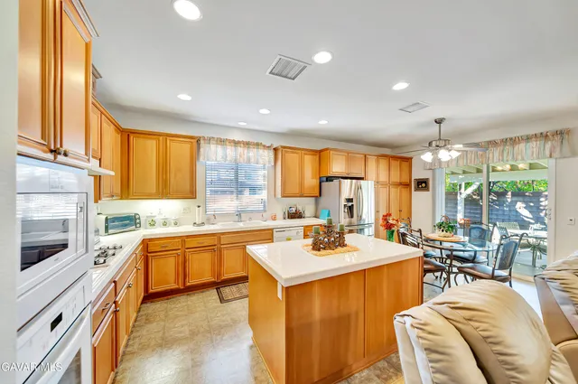 a view of a hallway with wooden floor and a living room