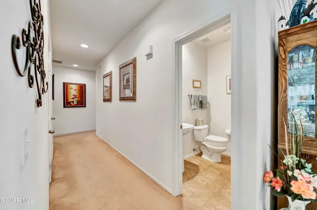 a view of a hallway with furniture and a living room