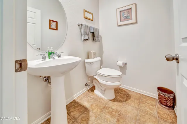 a bathroom with a granite countertop bathtub shower and toilet
