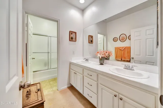 a spacious bedroom with a bed and a chandelier