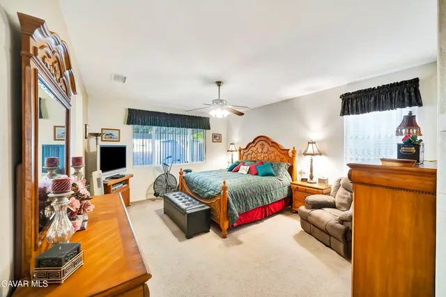 a spacious bathroom with a tub sink and mirror