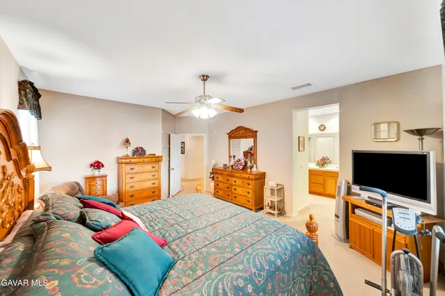 a white toilet sitting next to a wooden cabinet