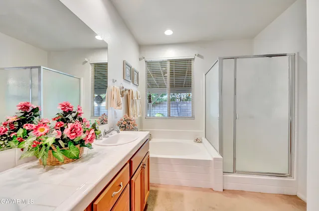 a view of a patio with table and chairs potted plants and large tree