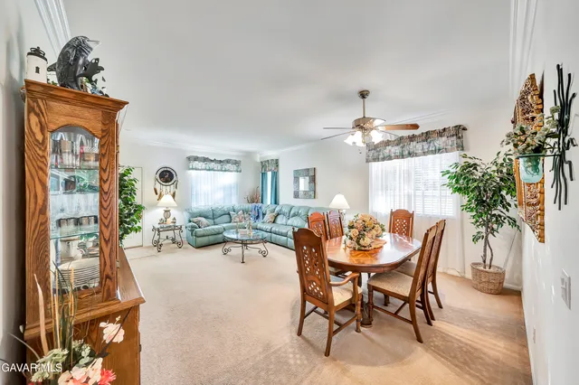 a view of a dining room with furniture a chandelier and wooden floor