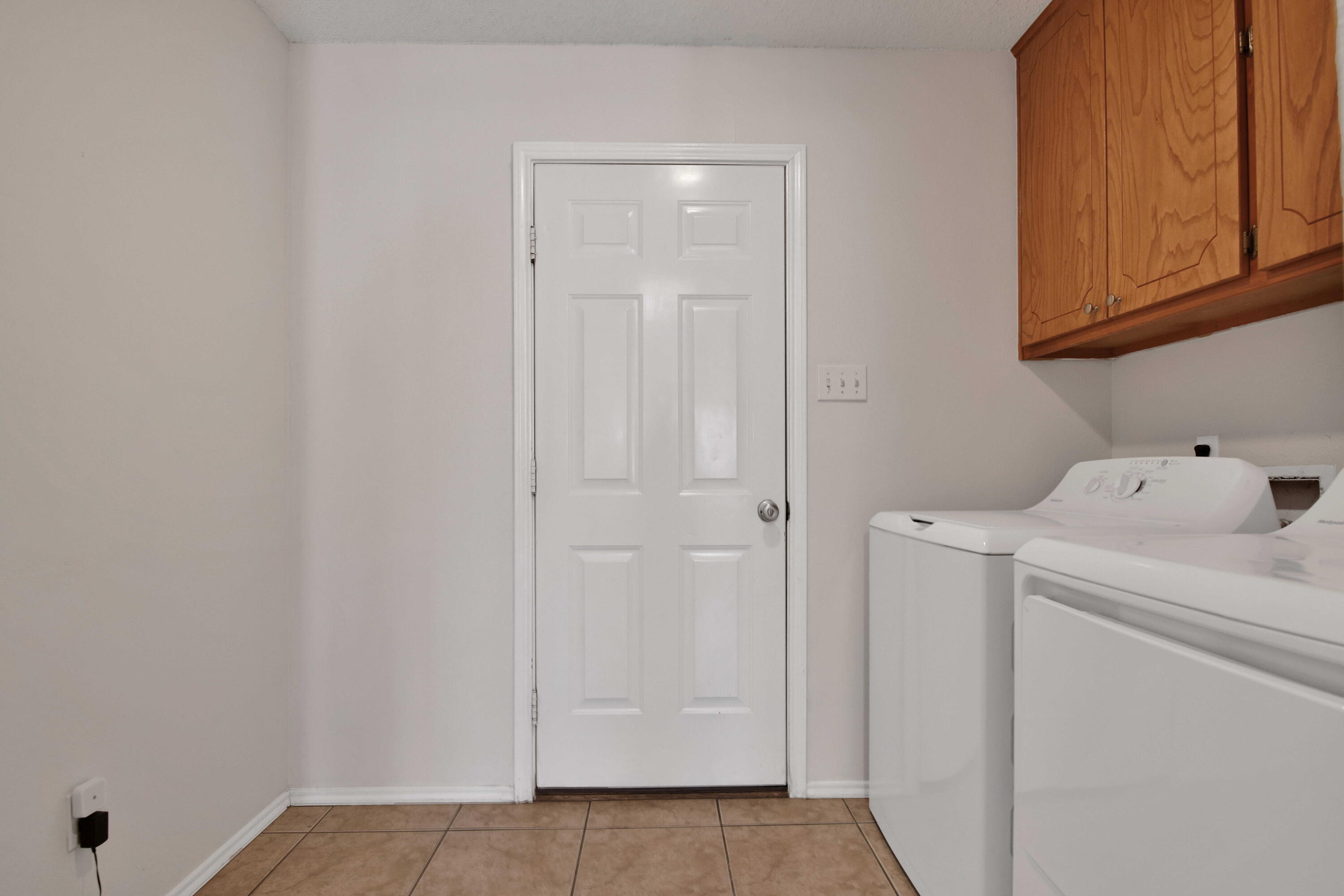 2907 90th Street Lubbock, TX 79423 - Photo 26 of 30 a view of storage and utility room with washer and dryer