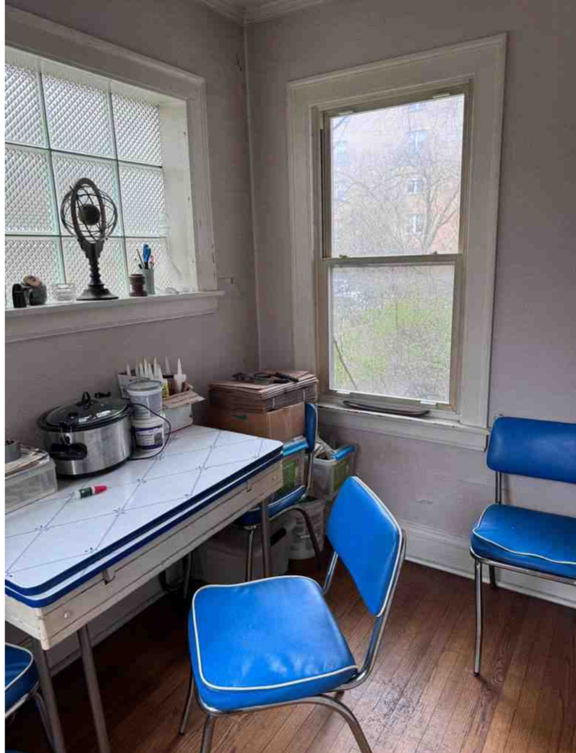2130 West Farwell Avenue Chicago, IL 60645 - Photo 5 of 14 a blue table sitting next to a window