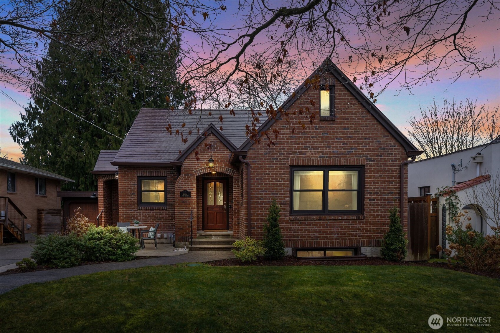 a front view of a house with a garden