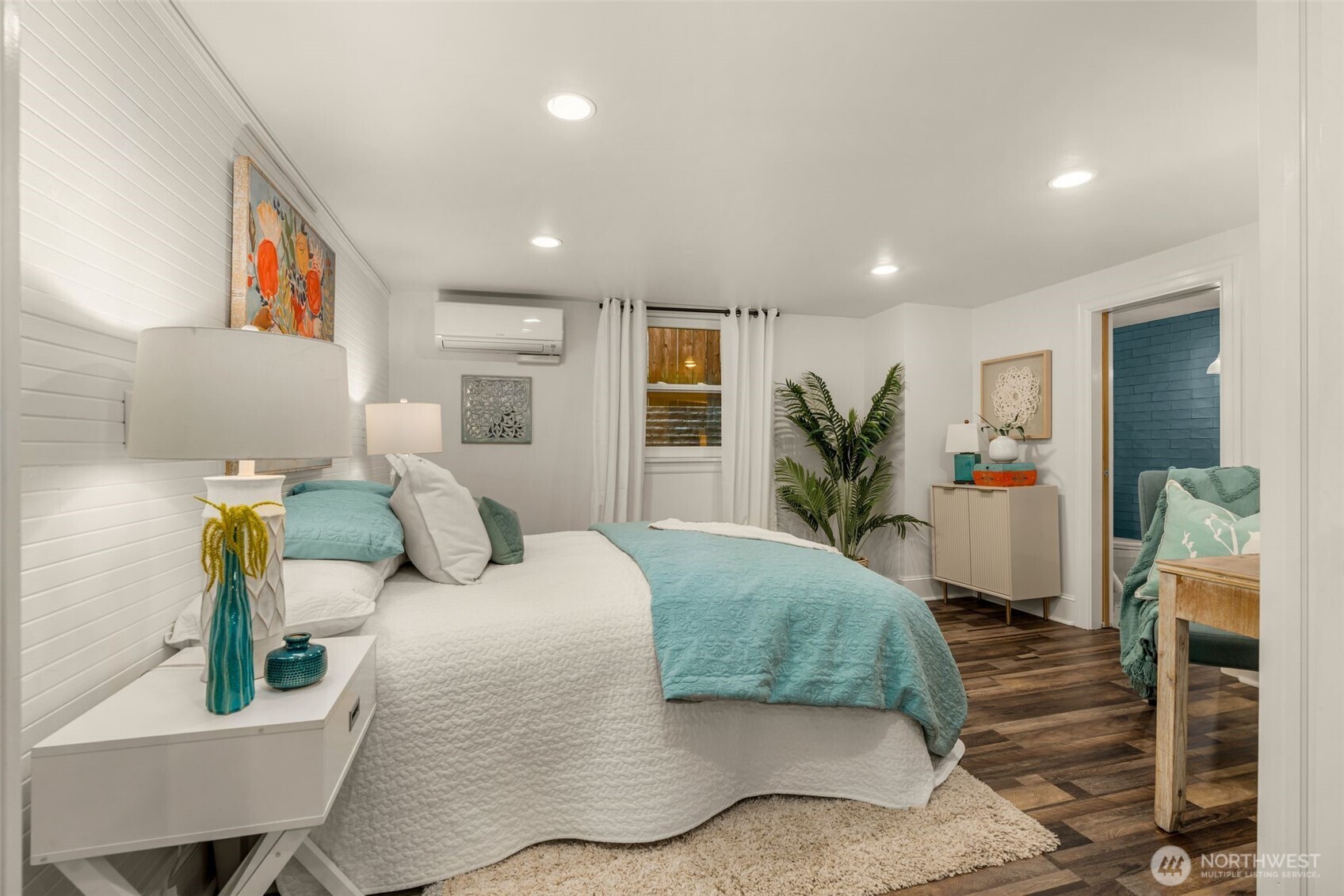 2351 47th Avenue Southwest Seattle, WA 98116 - Photo 27 of 40 a bedroom with a bed and wooden floor