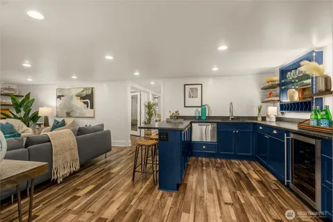 a living room with lots of furniture and kitchen view