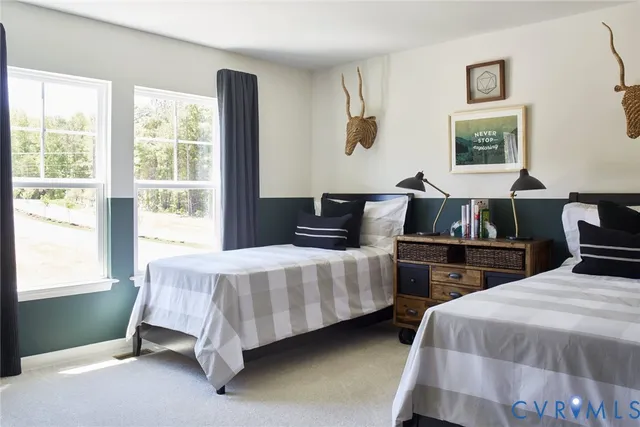 a bedroom with two beds and a large window