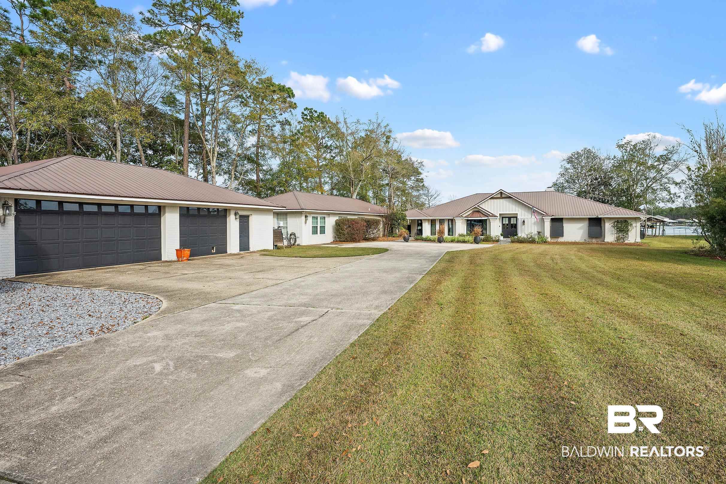 8490 Bay View Drive Foley, AL 36535 - Photo 66 of 67 Ranch-style house with driveway, a front yard, and a metal roof