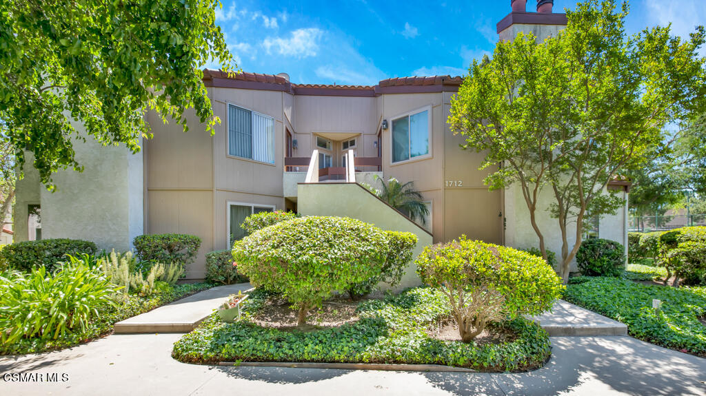 1712 Sinaloa Road, Unit 106 Simi Valley, CA 93065 - Photo 1 of 30 a front view of a house with a yard