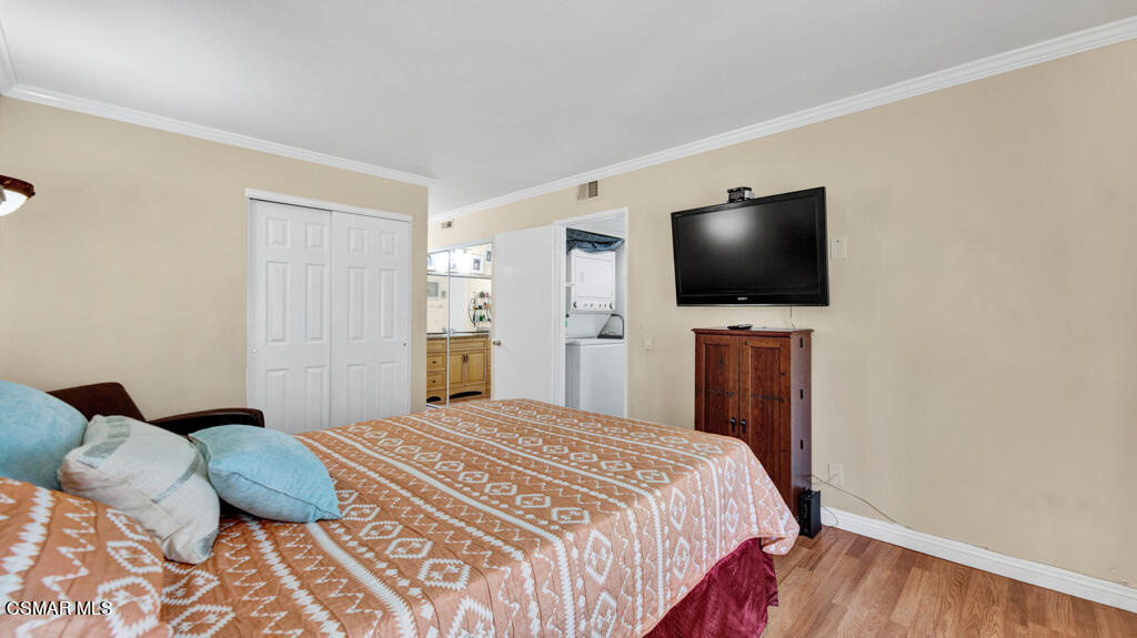 1712 Sinaloa Road, Unit 106 Simi Valley, CA 93065 - Photo 11 of 30 a bedroom with a bed and a flat screen tv