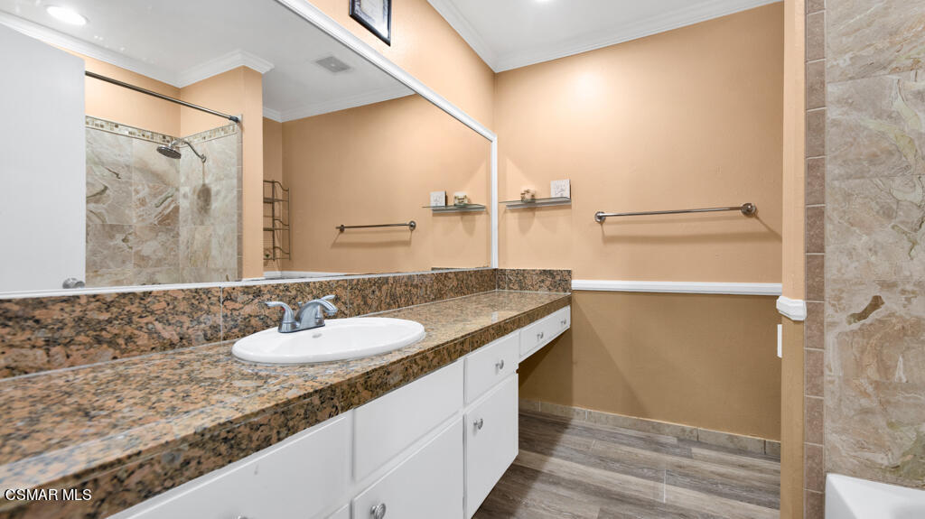 1712 Sinaloa Road, Unit 106 Simi Valley, CA 93065 - Photo 15 of 30 a bathroom with a granite countertop sink and a mirror
