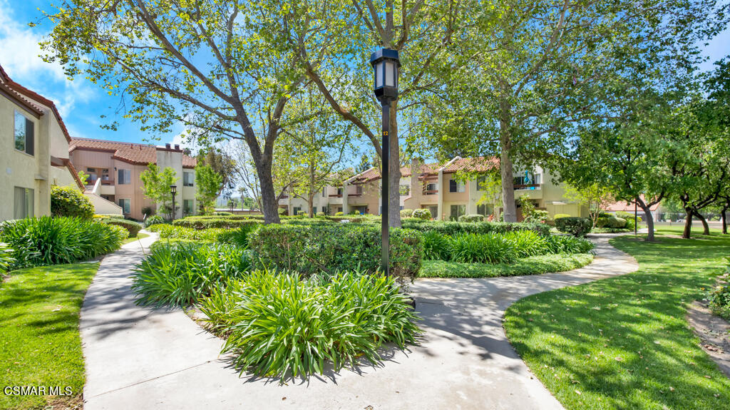 1712 Sinaloa Road, Unit 106 Simi Valley, CA 93065 - Photo 20 of 30 a front view of a house with a yard