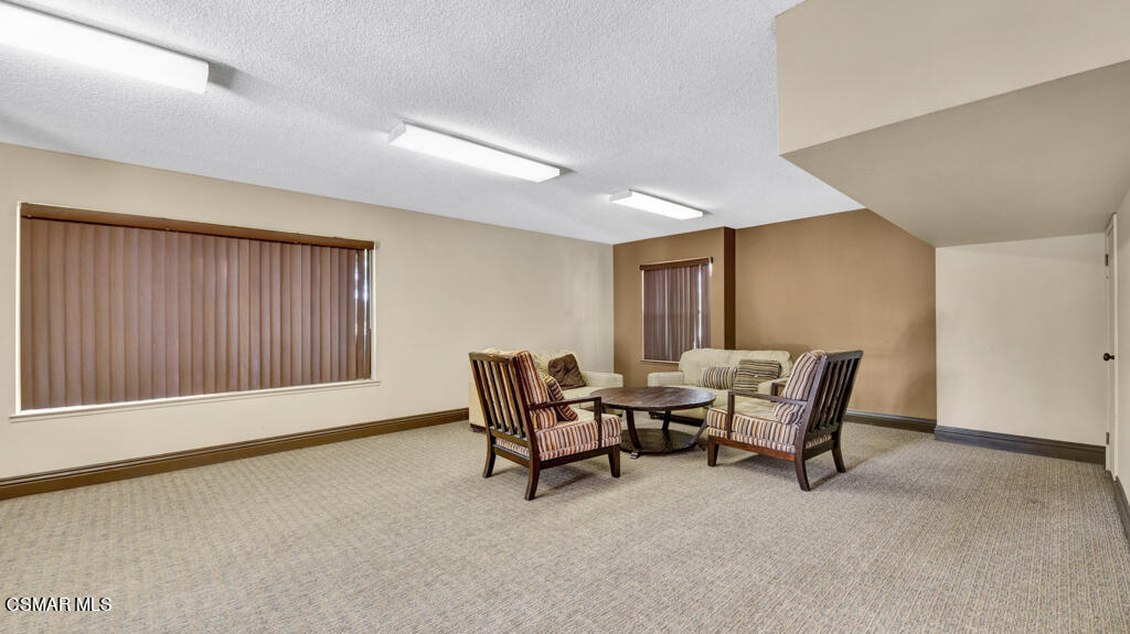 1712 Sinaloa Road, Unit 106 Simi Valley, CA 93065 - Photo 24 of 30 a living room with furniture and a window